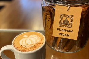 Pumpkin Pecan biscotti in wholesale display from Bucks County Biscotti behind pumpkin latte